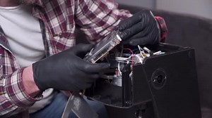 Coffee machine repair service. Handyman master fixing kitchen electronics equipment. Household appliances repair concept. Call repairmen of household appliances. Man repairing broken coffee machine
