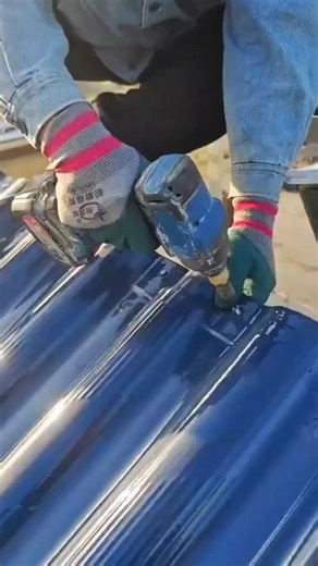 fastening blue corrugated roofing sheets using a manual electric power drill machine for work