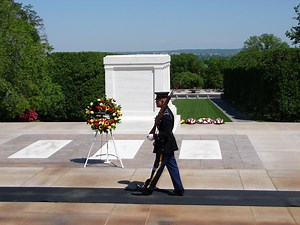 Soldier reminds noisy crowd of the importance of respect during memorial service.