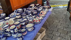 Ceramic tableware and home decorations for sale at a Christmas market in Europe, offering a variety of gifts and dining essentials