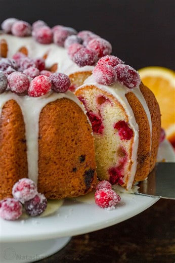 It’s the perfect Christmas cake covered in a simple orange glaze and studded with Sugared Cranberries. RECIPE: https://natashaskitchen.com/cranberry-bundt-cake/ #dessert #christmascake #holidaybaking #bundtcake | NatashasKitchen.com