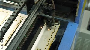 CNC machine cutting wood with a laser. CNC machine at work. Close-up.