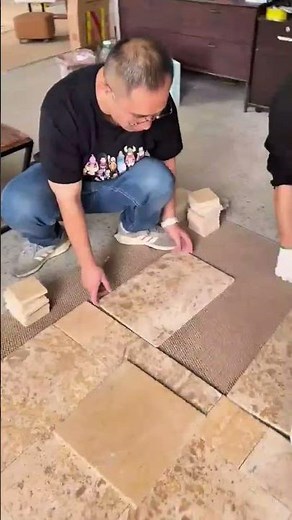 Arranging natural stone tiles in geometric pattern for decorative and durable floor surface design