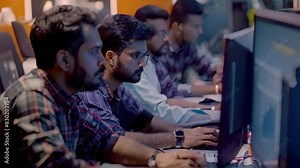 A group of Indian men sitting in front of a laptop computer, working together on software development, A group of Indian men collaborating on a software development project