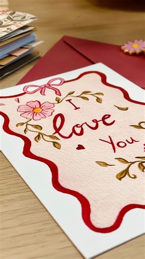 Alizée | Atelier Café-Aquarelle 🌷 on Instagram: "Une commande pour la St Valentin 🩷 On prépare ensemble une commande de coloriages aquarellables. 🎨 J’y ai glissé un petit cadeau : une jolie carte de saint-Valentin illustrée à l’aquarelle. Le lien de ma boutique est en bio 💌 #saintvalentin #amour #cadeaustvalentin"