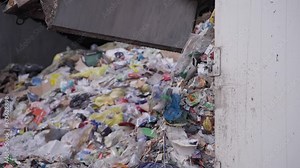 Close-up of waste truck unloading, managing and disposing of waste materials