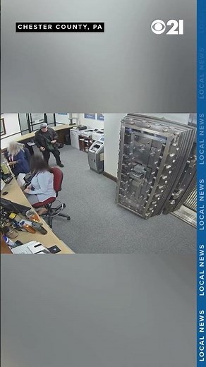 Bank robbery caught on camera, robber grabs teller's arm