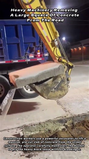 Heavy Machinery Removing A Large Square Of Concrete From The Road