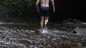 Man Walking Barefoot in a Stream | Free Stock Video Footage