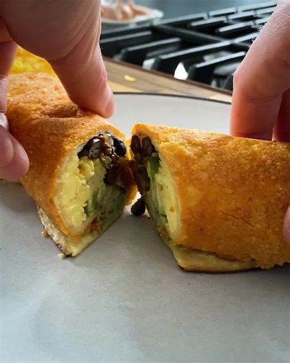 Breakfast burritos become even better when wrapped in a layer of crispy cheese and filled with chorizo. GET THE RECIPE: bit.ly/3qMUjMe | Food & Wine