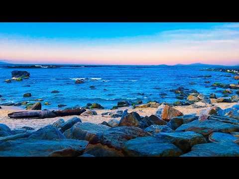 Blushing Sunset Rocky Beach | Calm Waves and Soft Horizon