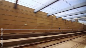 View from the window train moving in railway tunnel to railway station. Train moving fast in tunnel to railway station