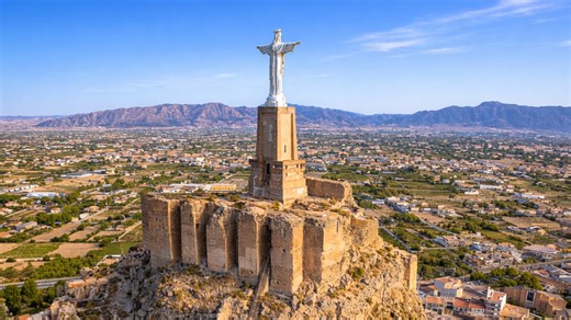 Why is this giant statue standing on a castle?