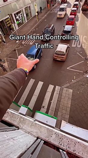 Erik Schmitt's Giant Hand Controlling Traffic