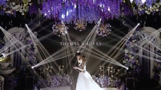 This wedding reception was designed with an Enchanted Garden concept, blending soft shades of violet and dusty blue to create a romantic and elegant ambiance. Towering floral trees framed the pathway, while cascading wisterias and layered blooms formed a canopy that brought the garden theme to life. The ceiling installation featured hanging florals, crystal accents, and warm amber lighting to add texture and visual depth. From the floral walls to the reflective aisle, every design element was ca