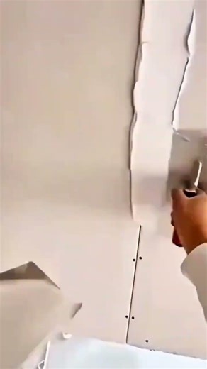 applying joint compound to drywall seams with a trowel for smooth finish wall surface construction