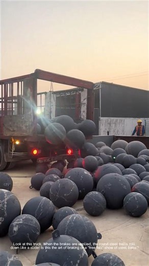 Creative operation of truck using inertia to unload round steel balls!
