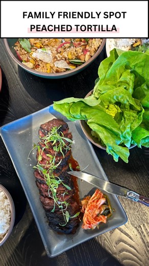 🍑 NEW popular restaurant, Peached Tortilla, has opened in Cedar Park with Southern food with an Asian twist! Vibe-y bar inside the restaurant and family-friendly back patio with turf that’s perfect for kids and dogs. [ what to expect ] 〰️ new dishes such as wok-fried garlic eggplant w/ black bean sauce & Nashville hot chicken bao (this location only) 〰️ love the Hanger Steak Ssam with kimchi and bib lettuce 〰️ bar with cocktails, wines, beer, & NA options 〰️ outdoor patio seating that’s kid-fri