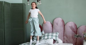 clip-1091031593-girl-have-fun-time-jump-on-bed