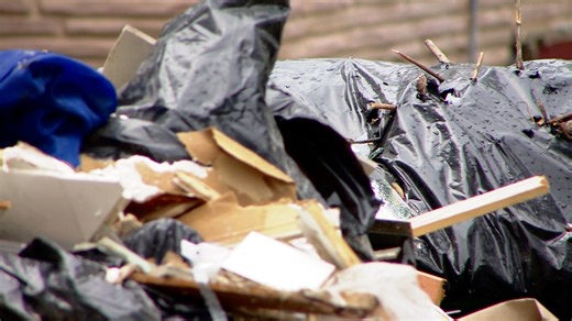 'Smelled to high heaven with flies everywhere': Neighbors fight to clean up junk pile outside vacant home