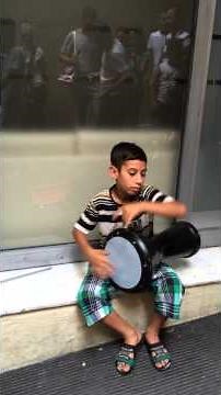 Talented little street musician in Taksim Square Istanbul plays goblet drum..