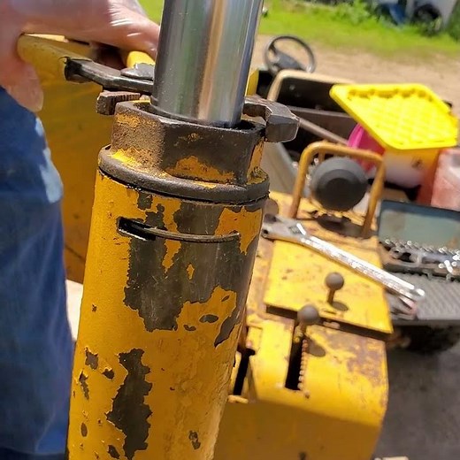 International 500 C Dozer Hydraulic cylinder gland removal.