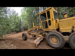 Clearing land with an excavator, grader, and making mountain roads