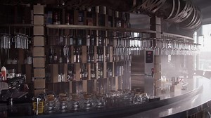 Restaurant counter decorated with wine bottles and glassware