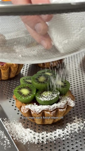 “Tastes like kiwi, but in a cute little shape,” owner of Amann Patisserie Yohann Godec says. When Godec spotted kiwi berries at Woolworths, he had an idea. He paired them with pandan – a flavour not traditional in French baking but inspired by his community – and raspberry jam. After a few tries, it worked, says his partner Alizée Le Goff. In this episode of How It’s Made, we step inside the Carlton North bakery to see how their kiwi pandan flan comes together. 📍 645 Nicholson Street, Carlton N