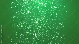 Shimmering bright particles floating on green screen background for magical visual effects in media production