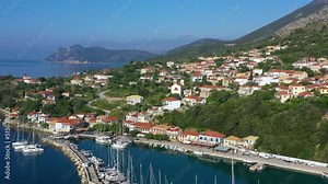 Small marina with catamaran yachts and sailboats in Greece. Kalamos Marina. Beautiful and cozy harbor in Greece. Old fishing village with port on the shore of the Ionian Sea. Travel by boat on the sea