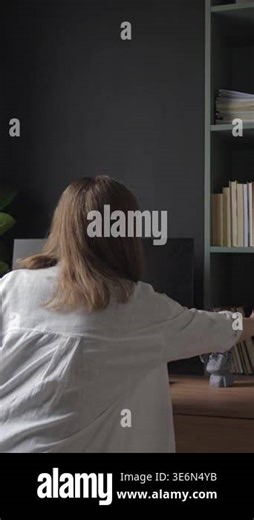 Back view of woman taking notebook from shelf and opening it in home office. Concept of remote work, planning and daily routine Stock Video Footage - Alamy