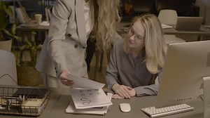 Free stock video - Two female employees talking together and checking reports in the office 2