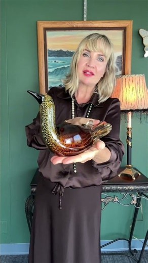 Vintage hand-blown art glass bird in warm amber-gold, flecked with shimmering aventurine. Smooth, sc