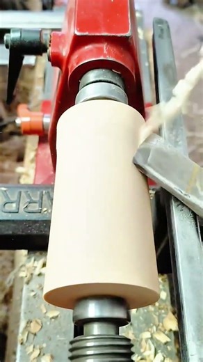 Skilled Woodworker Using a Lathe to Create a Smooth Cylindrical Object