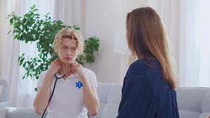 Female doctor using stethoscope to listen heart or lunges of woman patient. Nurse home visit, checking health of woman during coronavirus, covid-19 quarantine