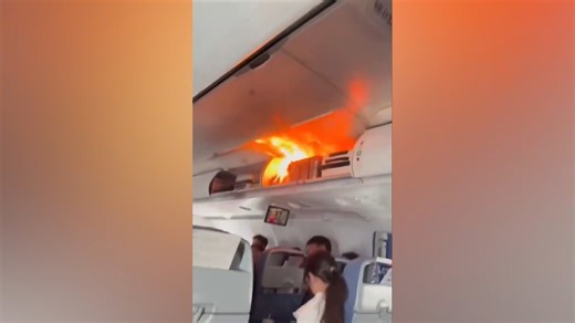 Video: Battery fire on Air China flight's overhead bin sparks panic among flyers