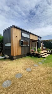 Could you live in this 300-sqft tiny house on wheels? Definitely one of my favorite tiny houses I've ever seen! Inside, this tiny home features 2 standing-height private bedrooms, a spacious living area with a sectional couch, a large U-shaped kitchen with tons of storage, & a full bathroom with a tile shower & a washer/dryer unit! Built by shayes_tiny_homes in New Zealand—please reach out to their team for updated pricing! #tinyhouse #tinyhome #tinyhouseonwheels #tinyhomeonwheels #smallhouse #m