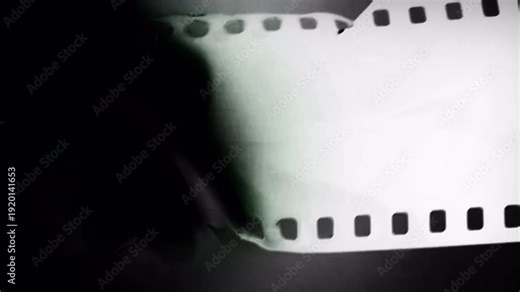 Cinematic film strip reveal with soft glow and analog texture. Perfect for retro transitions, vintage overlays, documentary intros, and abstract motion graphic backgrounds.