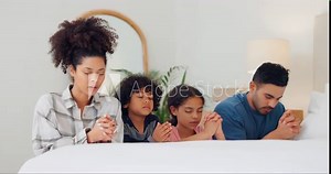 Bedroom, family and praying with faith, children or worship with God, bonding together or home. Parents, mother or father with kids, night or relax with unity, spiritual or religion with Christianity