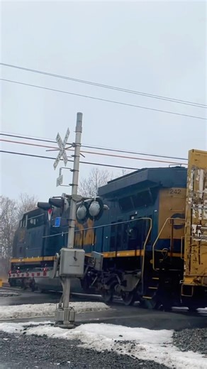 CSX rear DPU pushing hard through the crossing