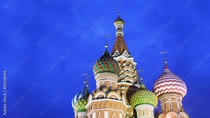 Colourful cupolas of Saint Basils Cathedral and cloudy sky at night in Moscow