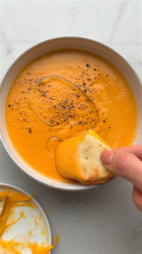Roasted Feta Tomato Soup - so creamy so so good! 🍅 INGREDIENTS 1 (8-ounce) feta chunk 1 red pepper, chopped 4 Roma tomatoes, chopped 1 onion, chopped 2 sprigs rosemary 1 bulb garlic, sliced at the top Freshly cracked black pepper ¼ cup olive oil 4 cups vegetable broth INSTRUCTIONS 1. Preheat the oven to 400°F. Line a large baking sheet with parchment paper. 2. Place the feta, peppers, tomatoes, onion, rosemary and garlic in on the prepared sheet pan. Season everything with black pepper and driz