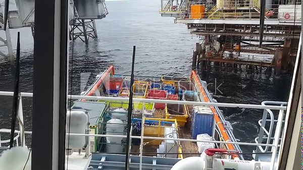 AHTS vessel is working in DP mode near OIL rig. fuel hose is connected. Boat is pitching and rolling