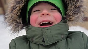 Happy Kid Having Fun on Carousel. Front View of Smiling Little Boy Enjoying an Merry-go-round Attraction. Amusement Kiddie Ride. POV. Carefree Young Child Spinning at Playground Carrousel Closeup Face