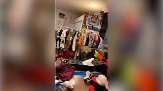 Chris Brown shows off all the clothing items at his yard sale