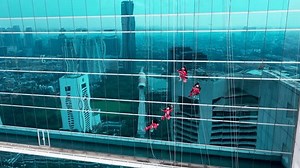 clip-1100790459-close-window-washers-on-skyscrapers-work