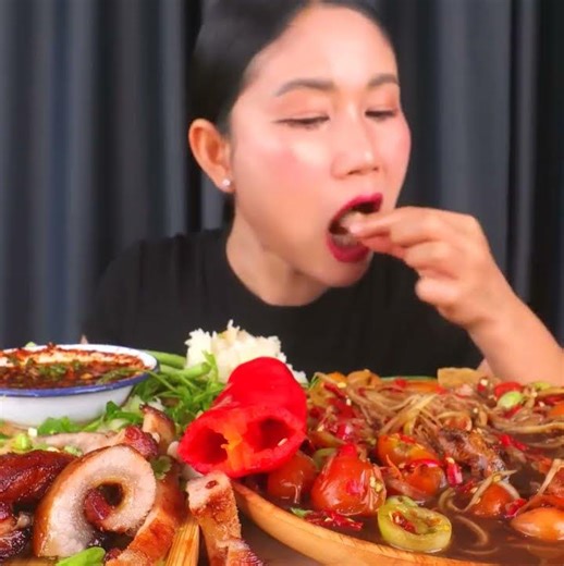 Eating spicy papaya salad with fermented fish sauce, grilled pork neck, and delicious