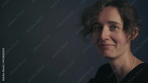 Candid Laugh of Youth Close up of a beautiful Slavic girl in a black shirt laughing and pointing at her head encouraging thoughtful reflection against a gray backdrop think your own head
