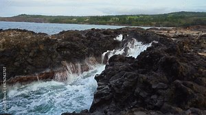 Waves crashing against the rocks in a cove at Makaluapuna Point in Maui, Hawaii.